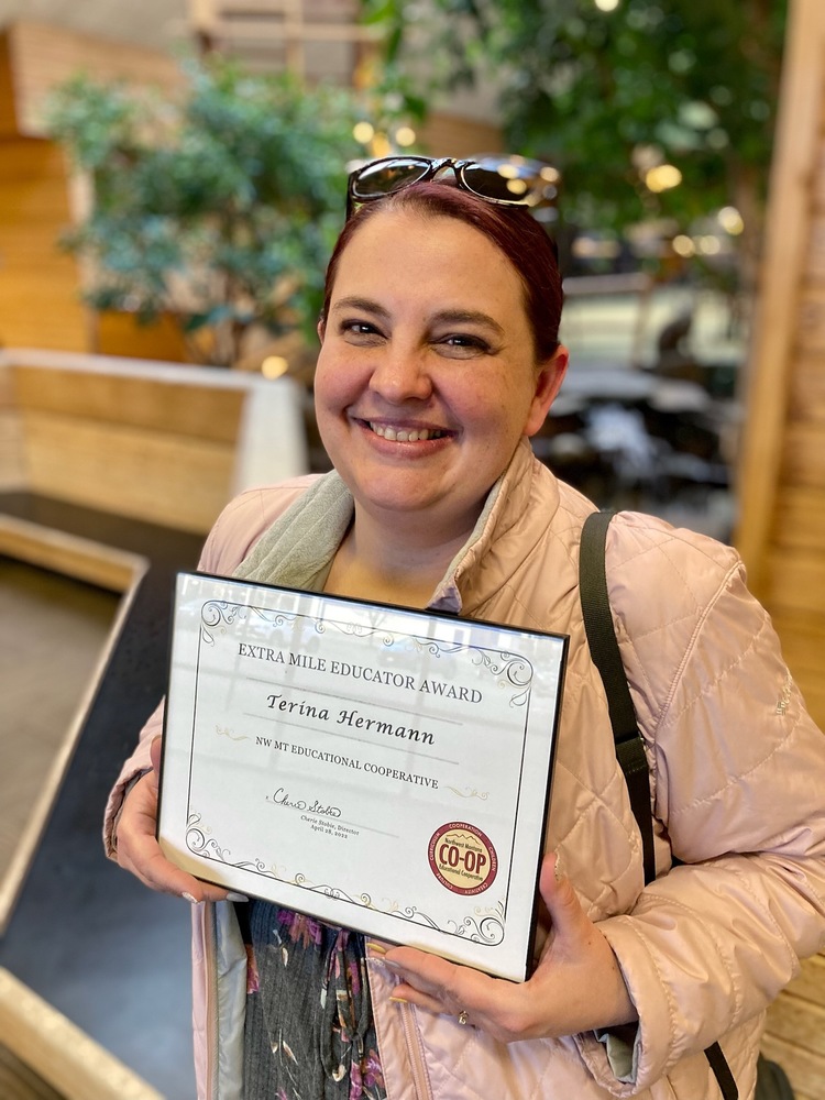 Picture of a Teacher holding her award