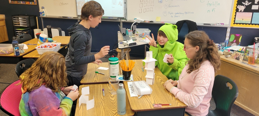 students building a tower with notecards