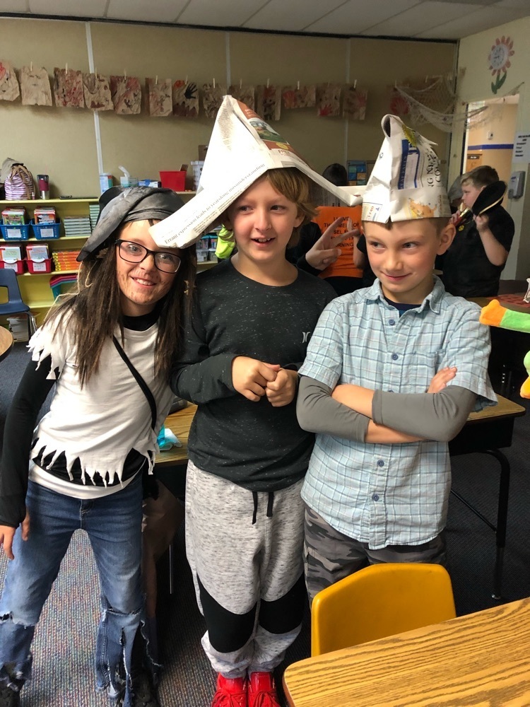 students modeling newspaper pirate hat
