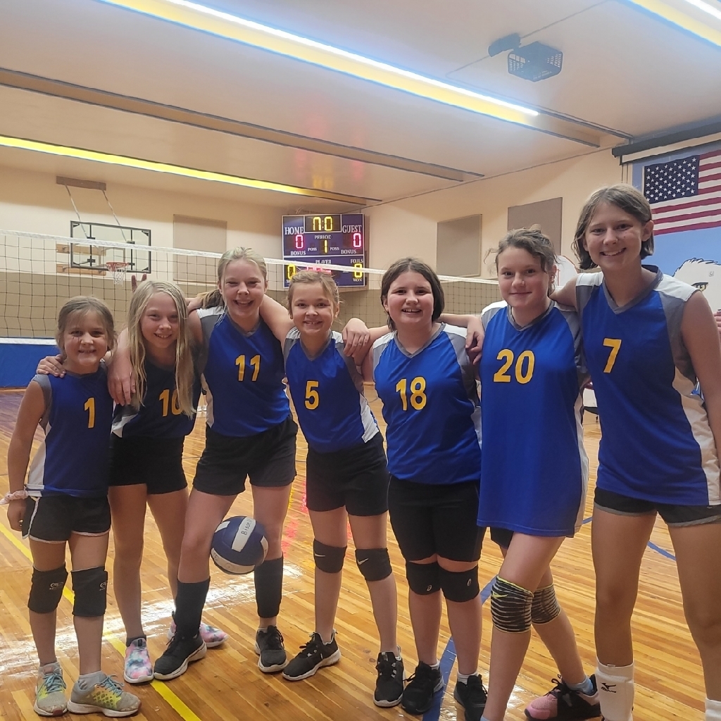 volleyball team in front of score board